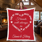 Woman holding personalized friends minky blanket with heart design by cabin fireplace