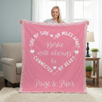 Person holding a pink blanket with text in a living room setting