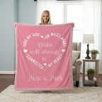 Person holding a pink blanket with text in a living room setting