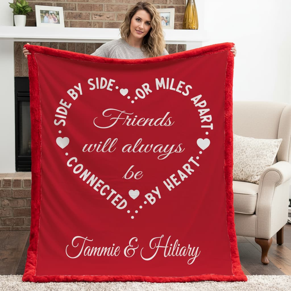 Woman holding personalized friends minky blanket with red self-bound trim by fireplace mantel
