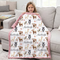 Little girl holding personalized goat and floral minky baby blanket with pink faux fur back