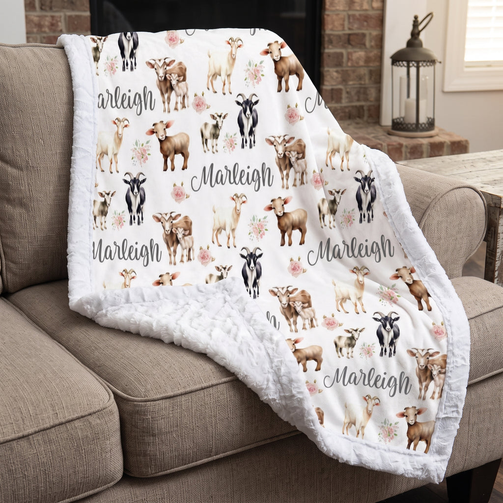 Personalized goat and floral minky baby blanket draped over armchair by a fireplace