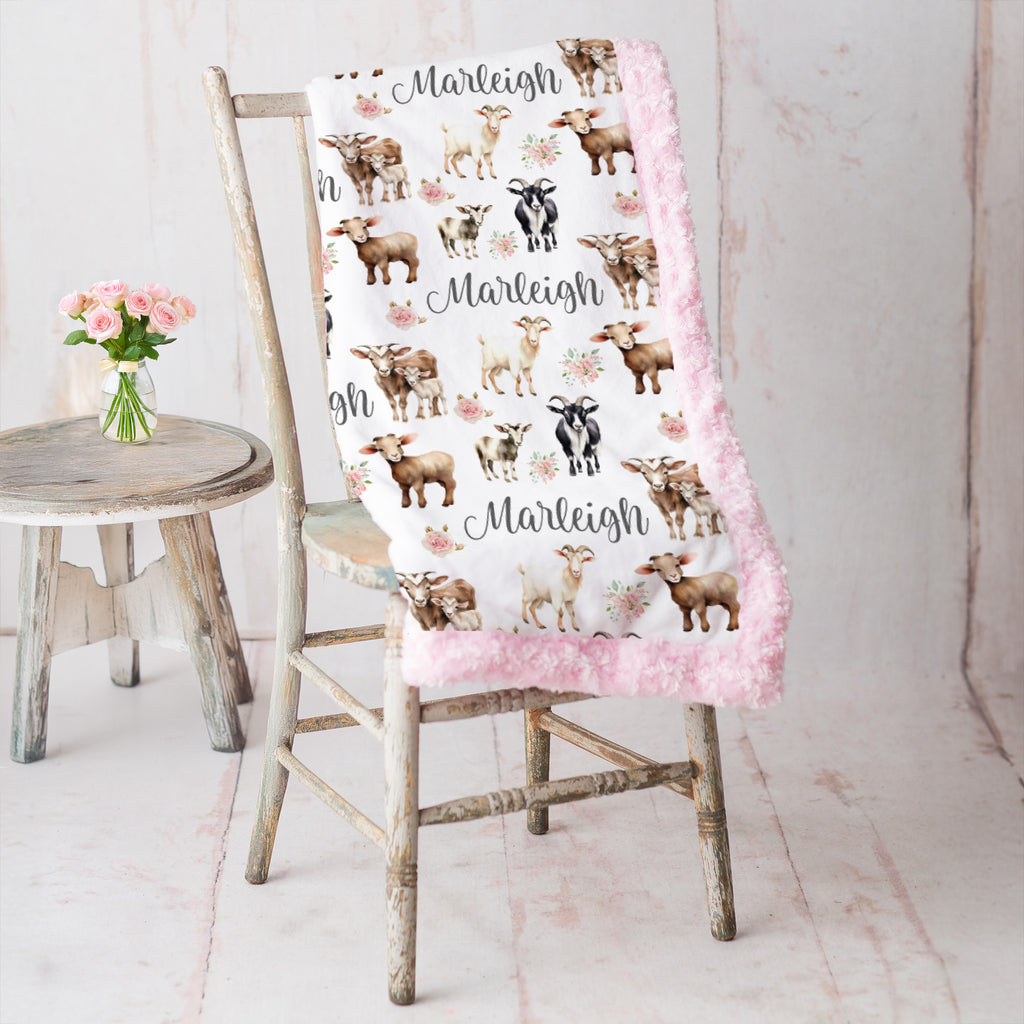 Personalized goat and floral minky baby blanket draped over vintage chair with pink roses