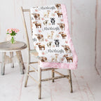 Personalized goat and floral minky baby blanket draped over vintage chair with pink roses