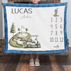 Personalized golf milestone baby blanket with name, held by child in front of brick fireplace