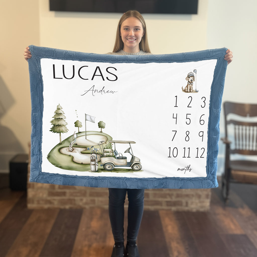 Woman holding personalized golf milestone baby blanket with name in living room