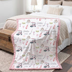 Personalized golf minky blanket with pink trim draped over bed