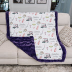 Personalized golf minky blanket with purple trim draped over couch