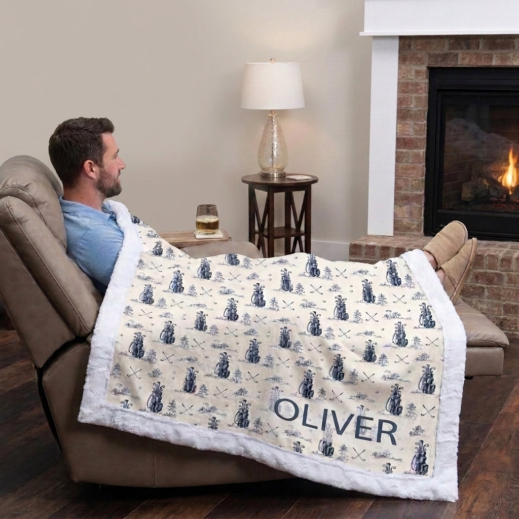Man relaxing in recliner with personalized golf minky blanket draped over legs by fireplace