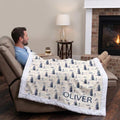 Man relaxing in recliner with personalized golf minky blanket draped over legs by fireplace