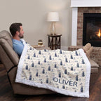 Man relaxing in recliner with personalized golf minky blanket draped over legs by fireplace
