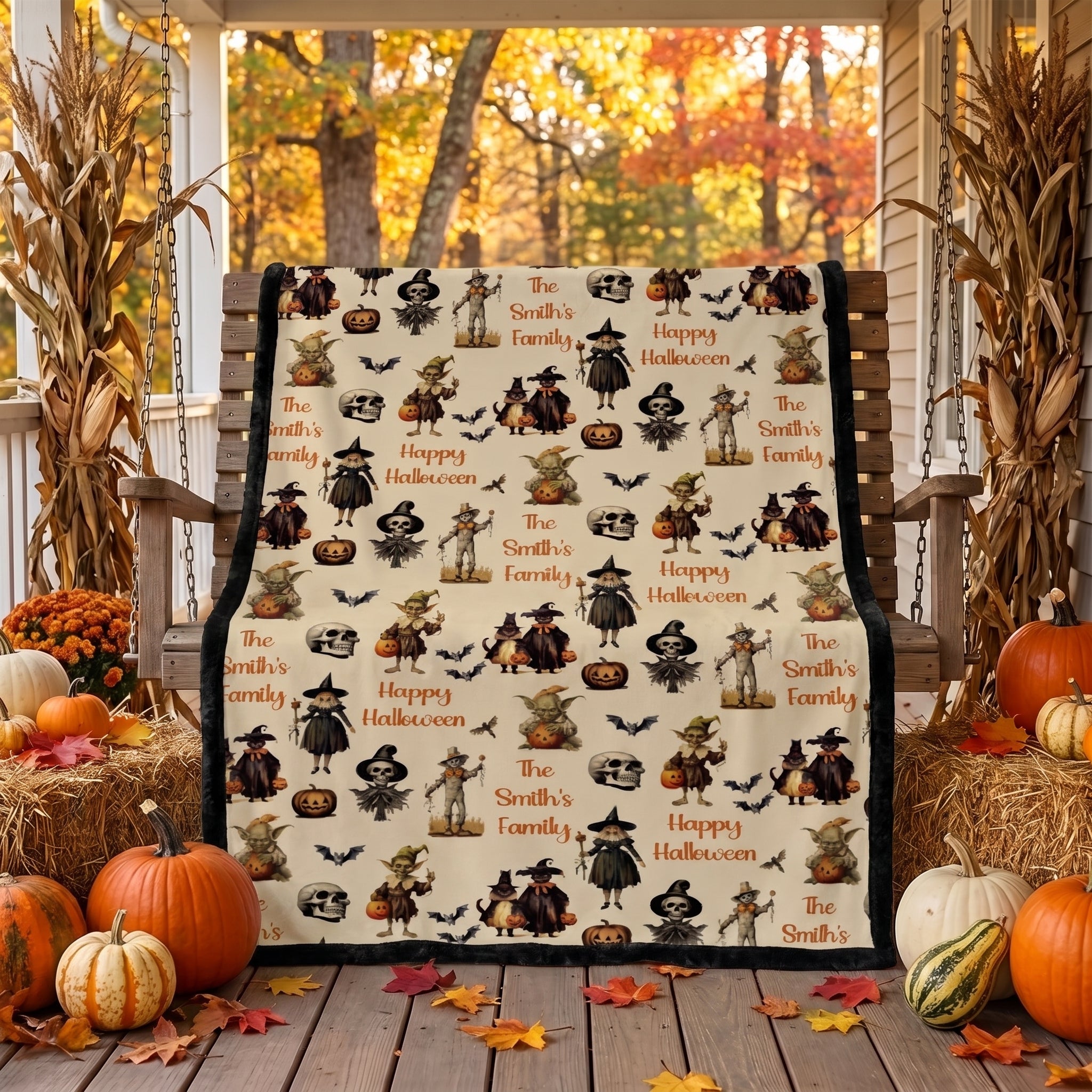 Personalized Halloween throw blanket draped over porch swing with cornstalks and pumpkins