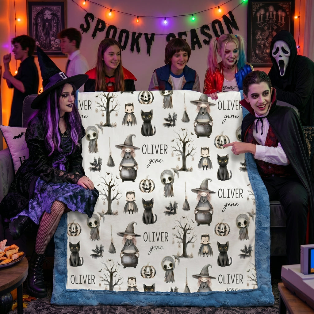 Halloween costume party group holding personalized minky blanket with blue trim and spooky season decor