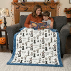 Mother and son reading a Halloween book under personalized minky blanket with blue trim on armchair