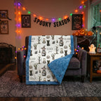 Personalized Halloween minky blanket with blue trim draped over armchair in spooky season decor