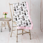 Personalized Halloween minky blanket with pink faux fur trim draped over vintage chair beside pink roses