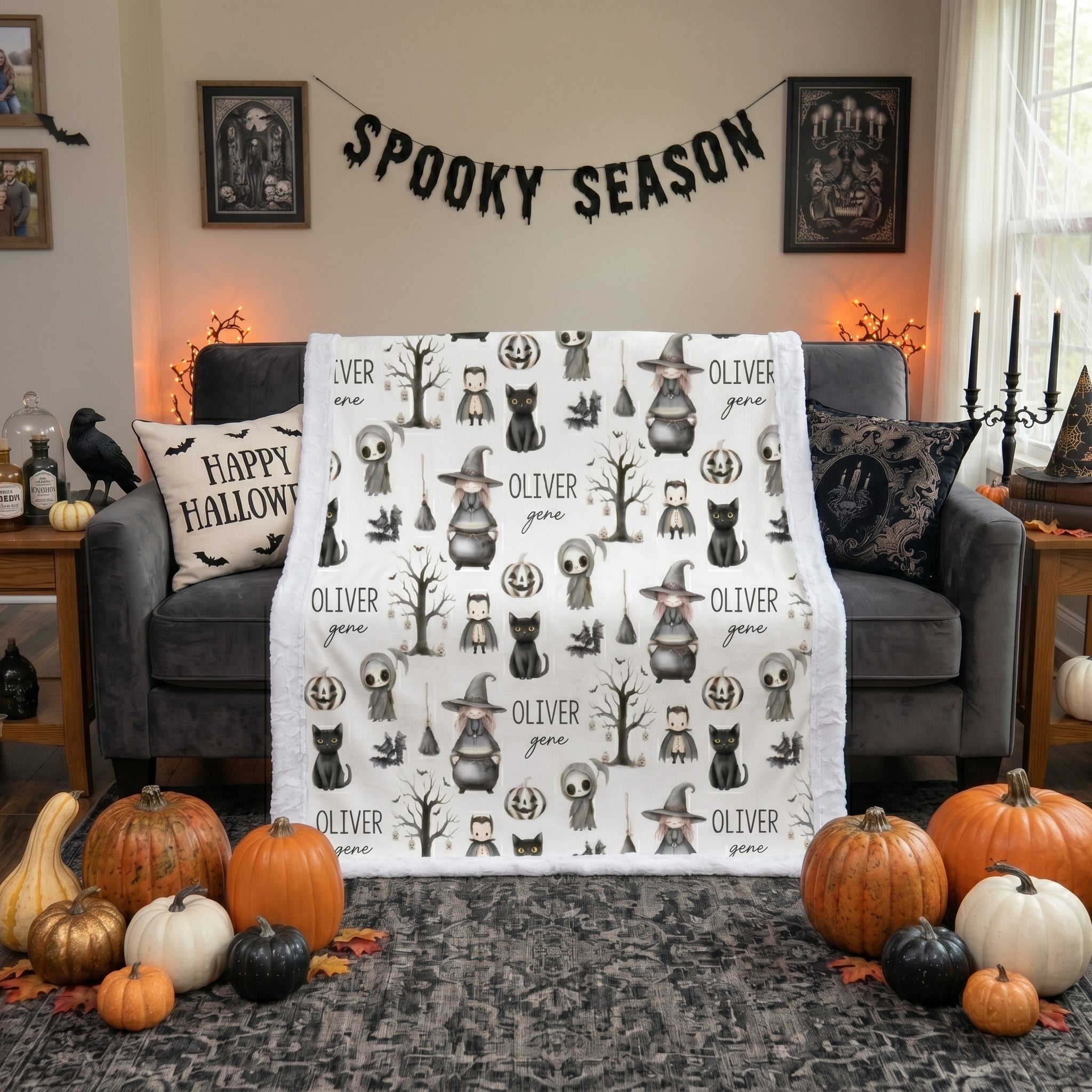 Personalized Halloween minky blanket with white trim draped over couch beside Happy Halloween pillow and pumpkins