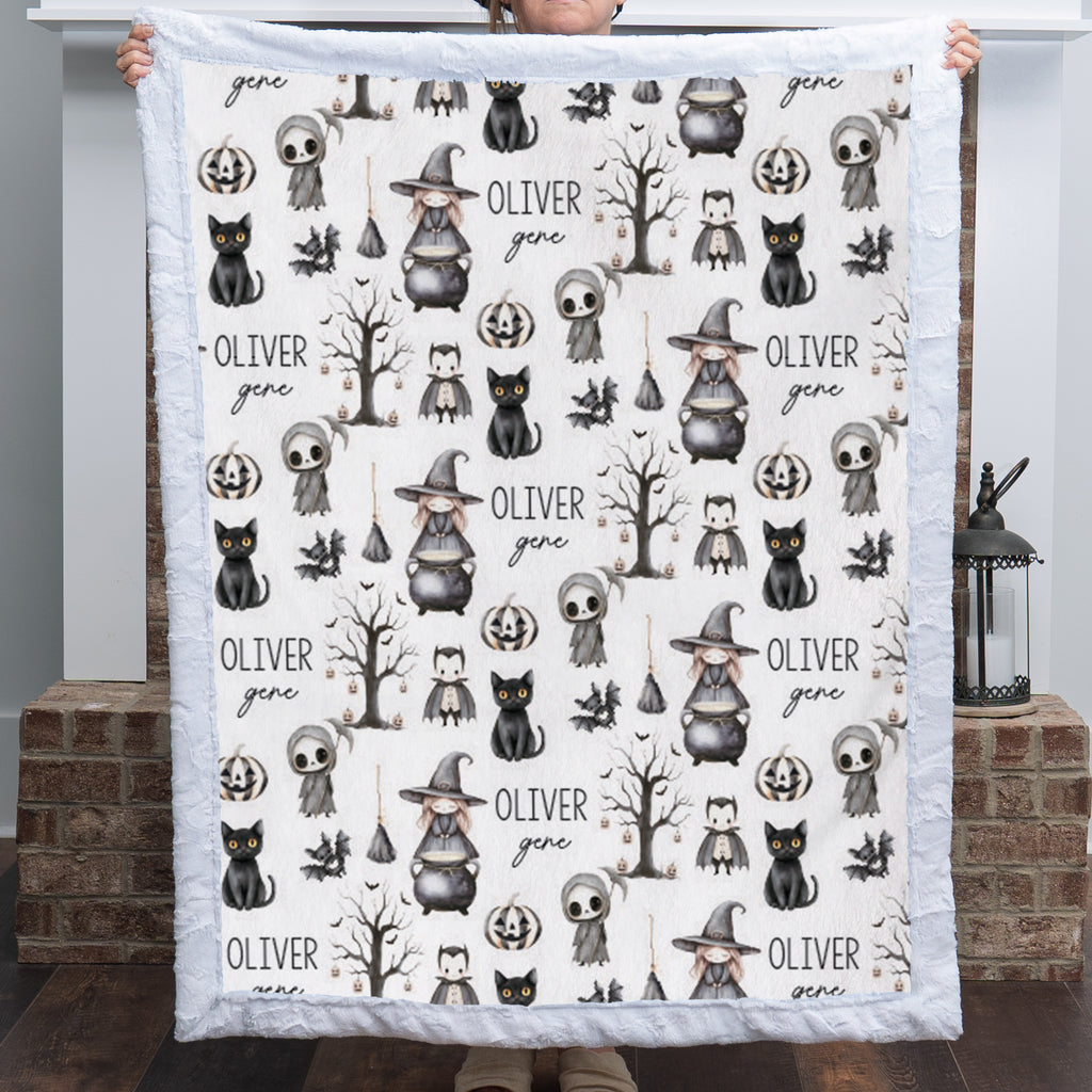 Woman holding personalized Halloween minky blanket with white faux fur trim over fireplace mantel