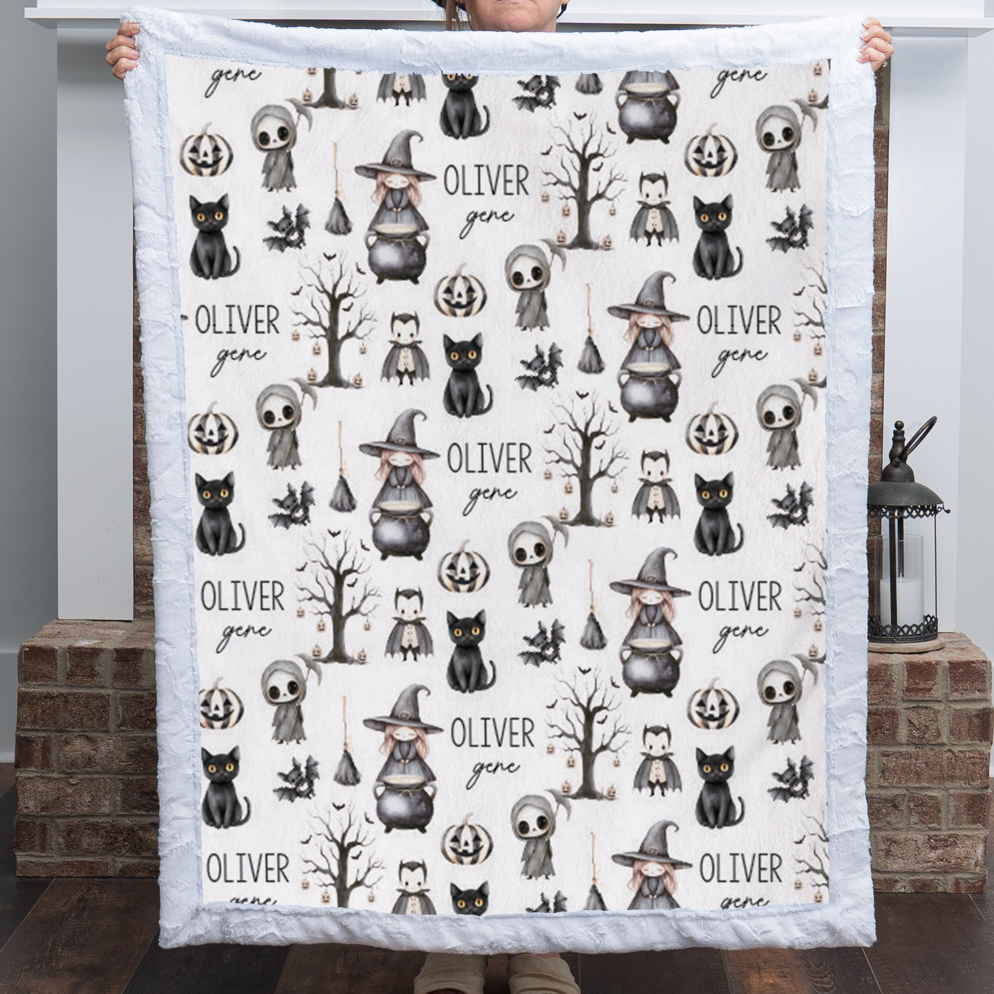 Woman holding personalized Halloween minky blanket with white faux fur trim over fireplace mantel