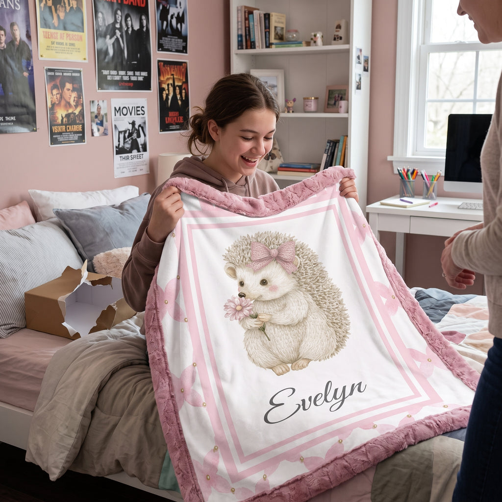 Girl holding open personalized Luxe Cuddle Minky hedgehog baby blanket with Evelyn name in bedroom