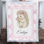 Personalized Luxe Cuddle Minky baby blanket with hedgehog and flower design, held by fireplace