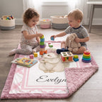 Toddlers playing with toys on personalized Luxe Cuddle Minky hedgehog baby blanket laid flat on floor