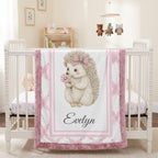 Personalized Luxe Cuddle Minky hedgehog baby blanket draped over white crib in nursery with mobile