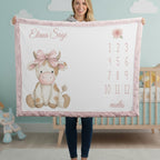 Woman holding personalized highland cow milestone baby blanket with custom name, pink faux fur trim