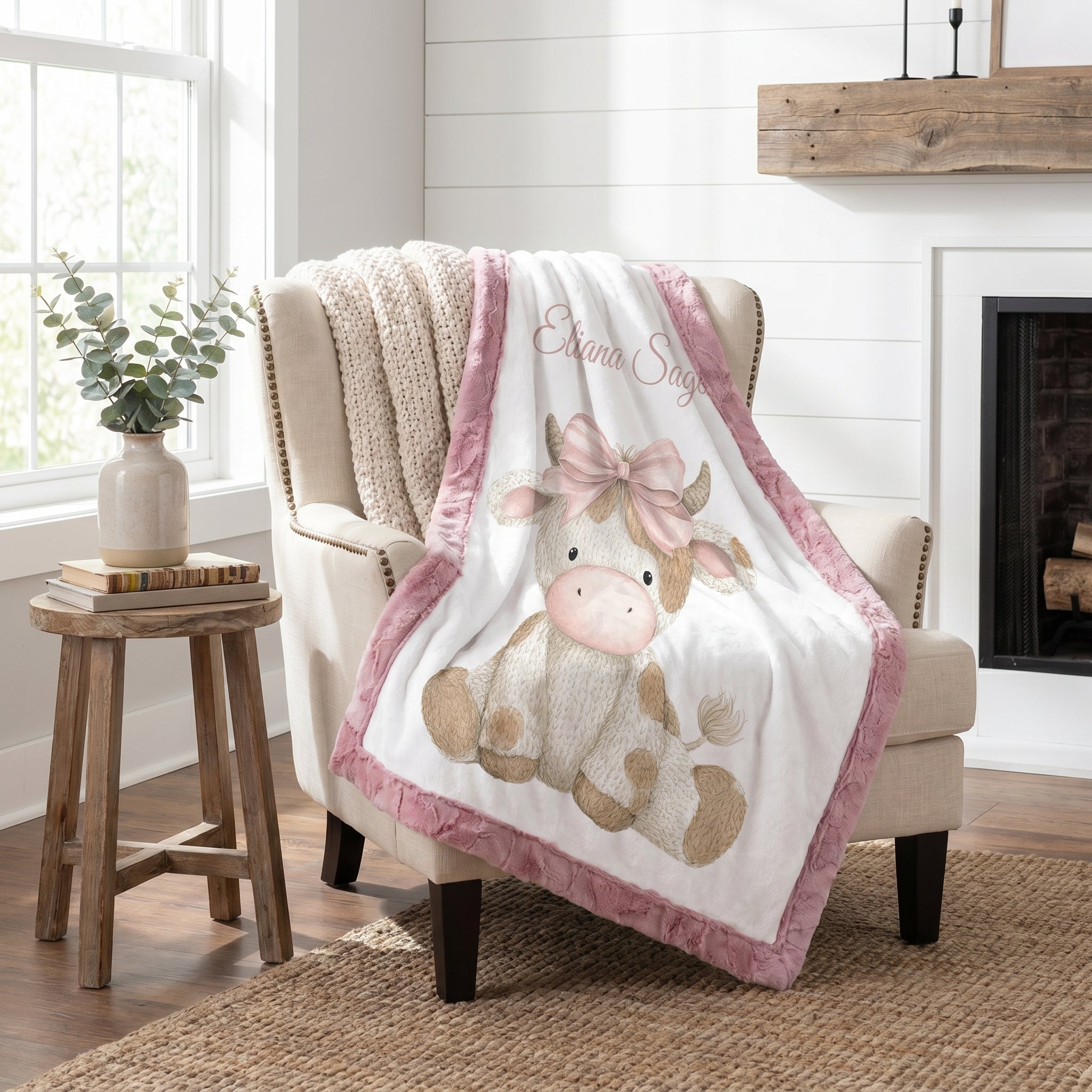 Personalized highland cow minky blanket with pink trim draped over armchair
