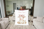 Woman holding personalized highland cow minky blanket with white sherpa back in living room