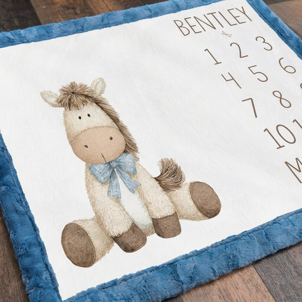 Close-up of personalized horse milestone blanket corner with blue faux fur trim