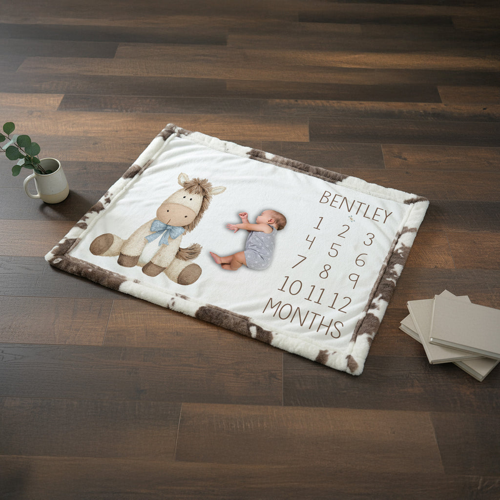 Personalized horse milestone blanket flat lay with newborn photo, cow print faux fur trim