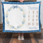 Personalized milestone minky blanket with hydrangea wreath held up close by child