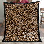 Woman holding personalized leopard print minky blanket with black trim