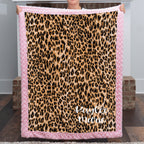 Woman holding personalized leopard print minky blanket with pink trim