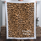 Woman holding personalized leopard print minky blanket with white trim