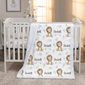 Personalized minky lion baby blanket draped over white crib rail in sunlit nursery