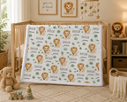 Personalized lion baby blanket with white minky trim draped over crib in safari nursery