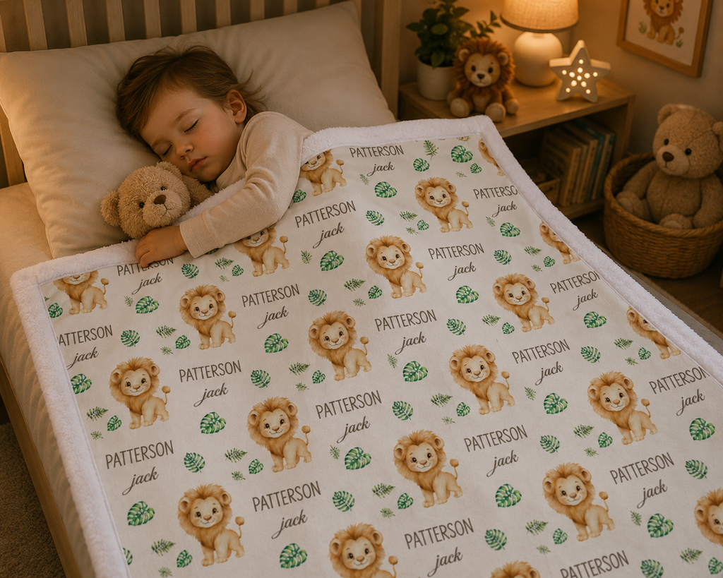 Toddler sleeping with personalized lion baby blanket, white minky trim, in cozy nursery bed