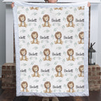 Personalized minky lion baby blanket with white fur border held up by fireplace with lantern