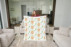 Woman holding personalized lion baby blanket with white minky trim in open-concept kitchen