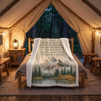 Personalized mountain lake blanket with a Dad message draped over a rustic bed in a glamping tent