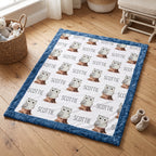 Personalized owl minky blanket with blue trim folded flat lay on wood floor