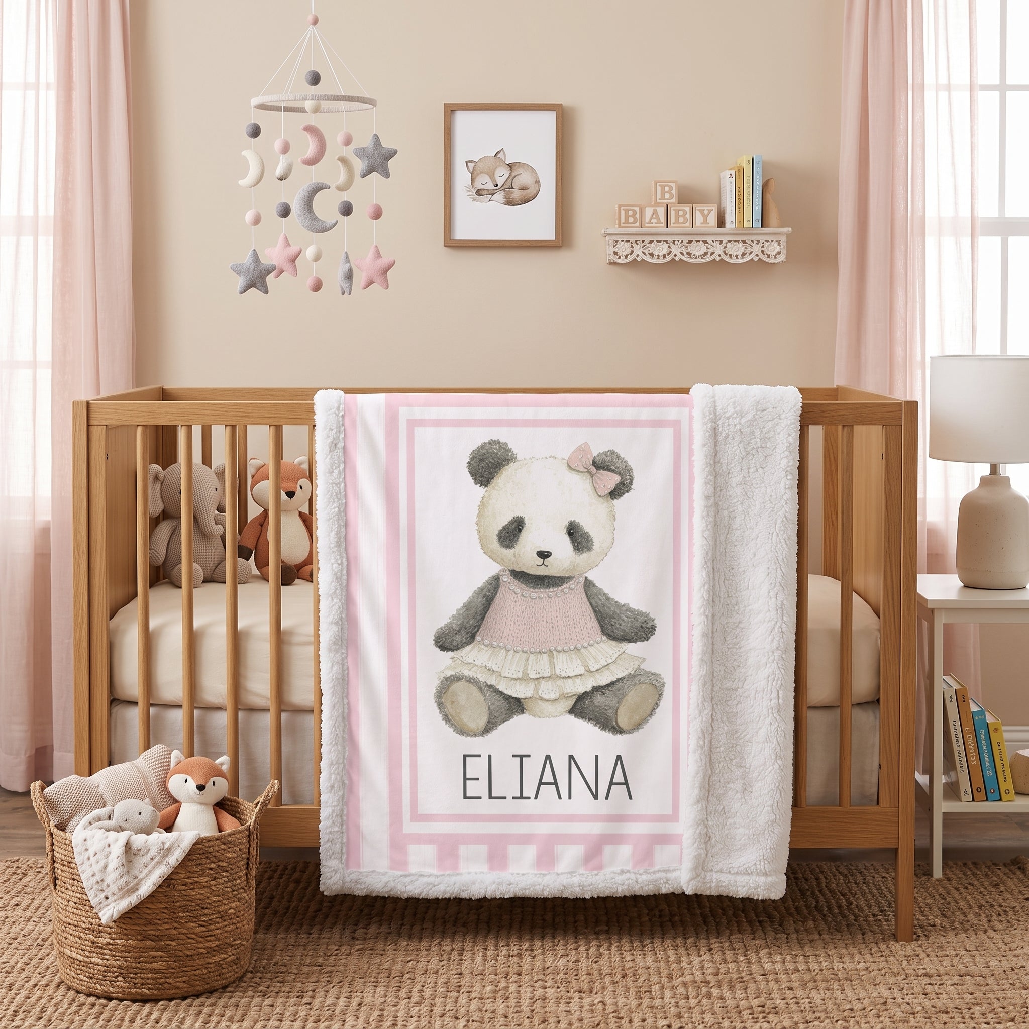 Personalized minky panda baby blanket draped over wooden crib in boho nursery