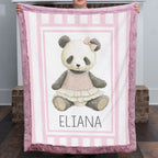 Personalized minky panda baby blanket with mauve pink fur border by fireplace