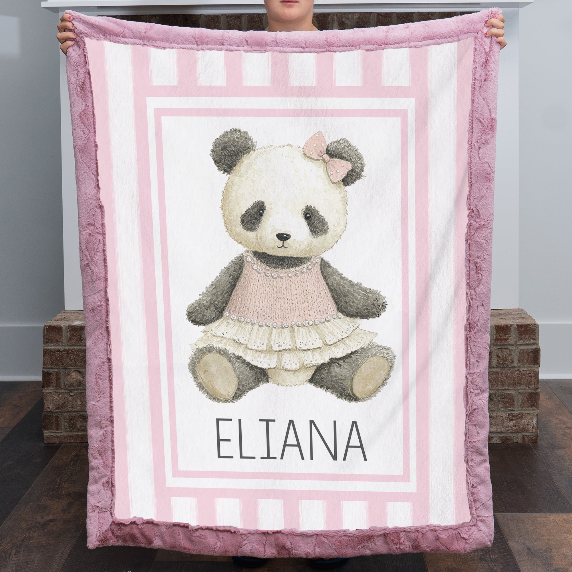 Personalized minky panda baby blanket with mauve pink fur border by fireplace