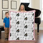 Mother and son holding personalized piano minky blanket with pink trim near a grand piano