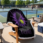 Personalized purple pickleball blanket with name Nicole hanging over a pickleball court sideline chair
