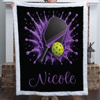 Personalized purple pickleball blanket with paddle and ball splash design and the name Nicole
