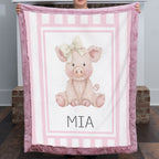 Personalized Luxe Cuddle Minky pig baby blanket with mauve pink border by fireplace